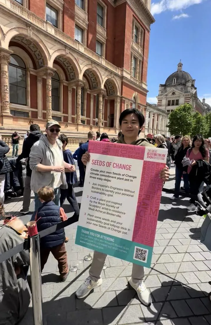 Sun with the EWB Seeds of Change poster at the Great Exhibition Road Festival